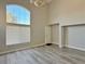 Spacious living room with soaring ceilings, arched window and modern gray flooring at 8717 Harvest Valley Ave, Las Vegas, NV 89129