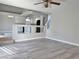 Open living space featuring partial wall to the kitchen area and modern gray flooring at 8717 Harvest Valley Ave, Las Vegas, NV 89129