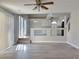 View of living room with partial-height wall to kitchen, slider to backyard and wood-look floors at 8717 Harvest Valley Ave, Las Vegas, NV 89129