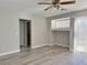 Neutral living room featuring wood-look flooring, niche shelving and slider to the back yard at 8717 Harvest Valley Ave, Las Vegas, NV 89129