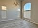 Bright living room featuring tall ceilings, transom windows and contemporary gray flooring at 8717 Harvest Valley Ave, Las Vegas, NV 89129