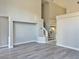 Open-concept living area with staircase, built-in shelving and modern gray flooring at 8717 Harvest Valley Ave, Las Vegas, NV 89129