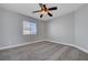 Bedroom featuring a ceiling fan, a window, neutral colored walls, and carpet flooring at 9004 Snowtrack Ave, Las Vegas, NV 89149