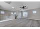 Upstairs bonus room features carpeting, a ceiling fan, and abundant natural light at 9004 Snowtrack Ave, Las Vegas, NV 89149