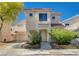 Charming two-story home with a red tile roof, landscaped front yard and attached two car garage at 9004 Snowtrack Ave, Las Vegas, NV 89149