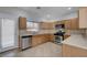 Well-lit kitchen features stainless steel appliances, tile countertops, and wood cabinetry at 9004 Snowtrack Ave, Las Vegas, NV 89149