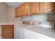 Convenient laundry room featuring overhead cabinets, countertop space and a washer and dryer at 9004 Snowtrack Ave, Las Vegas, NV 89149