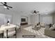 Spacious, open-concept living room featuring tile floors and a stylish ceiling fan and access to entry at 9004 Snowtrack Ave, Las Vegas, NV 89149