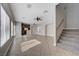Bright, open living room with tile floors, ceiling fans, and staircase to the second floor at 9004 Snowtrack Ave, Las Vegas, NV 89149