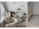 Bright, open living room with tile floors, ceiling fans, and staircase to the second floor at 9004 Snowtrack Ave, Las Vegas, NV 89149