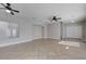 Spacious, open-concept living room featuring tile floors and a stylish ceiling fan and access to entry at 9004 Snowtrack Ave, Las Vegas, NV 89149