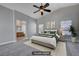 Staged main bedroom with a luxurious bed, tasteful decor, and an ensuite bathroom at 9004 Snowtrack Ave, Las Vegas, NV 89149