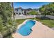 Aerial view of a backyard with a pool, green lawn, and privacy wall at 9208 November Breeze St, Las Vegas, NV 89123