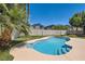 Backyard featuring a freeform pool, green lawn, and privacy wall at 9208 November Breeze St, Las Vegas, NV 89123