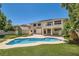 Home's backyard featuring a freeform pool, manicured lawn, and patio at 9208 November Breeze St, Las Vegas, NV 89123
