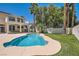 Spacious backyard featuring a freeform pool and manicured lawn at 9208 November Breeze St, Las Vegas, NV 89123
