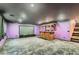 Finished basement with a large movie screen and a custom bar at 9208 November Breeze St, Las Vegas, NV 89123