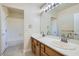 Well-lit bathroom featuring double sinks and a separate shower and bath at 9208 November Breeze St, Las Vegas, NV 89123