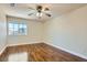 Bedroom featuring sleek hardwood floors and a bright window at 9208 November Breeze St, Las Vegas, NV 89123