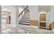 This home features a grand two-story entryway with marble flooring and a staircase at 9208 November Breeze St, Las Vegas, NV 89123