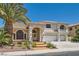 Attractive two-story home featuring a stucco exterior, tile roof, three-car garage, and verdant landscaping at 9208 November Breeze St, Las Vegas, NV 89123