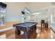 Well-lit game room with hardwood floors, a pool table, and windows with views at 9208 November Breeze St, Las Vegas, NV 89123
