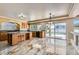 Bright kitchen features wood cabinets, island with granite counters, stainless steel appliances, and access to backyard at 9208 November Breeze St, Las Vegas, NV 89123