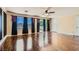 This living room boasts wood floors and large windows with backyard view at 9208 November Breeze St, Las Vegas, NV 89123