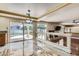 Open living room features a stone fireplace, backyard access, wet bar, and view of pool at 9208 November Breeze St, Las Vegas, NV 89123