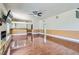 Open living room features a stone fireplace, backyard access, wet bar, and wood floors at 9208 November Breeze St, Las Vegas, NV 89123
