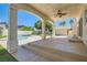 Covered patio overlooking a sparkling pool and lush backyard at 9208 November Breeze St, Las Vegas, NV 89123