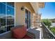 Inviting balcony features cushioned chair, sliding glass door access, and wrought iron railing at 9450 Niagara Landing St, Las Vegas, NV 89139