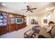 Finished basement with carpet and a ceiling fan, and an entertainment center, stairs in background at 9450 Niagara Landing St, Las Vegas, NV 89139