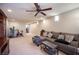 Spacious finished basement with carpet and a ceiling fan, a set of stairs to the upper level at 9450 Niagara Landing St, Las Vegas, NV 89139