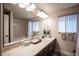 Bathroom with double sink vanity and framed mirror at 9450 Niagara Landing St, Las Vegas, NV 89139