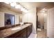 Bathroom boasts dual sinks with a granite countertop, and tile floors at 9450 Niagara Landing St, Las Vegas, NV 89139