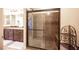 Bathroom with a glass-enclosed shower with a built-in bench and tile at 9450 Niagara Landing St, Las Vegas, NV 89139