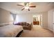 Cozy bedroom with neutral walls, soft carpet, and couch near the bed at 9450 Niagara Landing St, Las Vegas, NV 89139