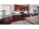 Well-lit kitchen boasts granite countertops, dark wood cabinetry, and modern appliances at 9450 Niagara Landing St, Las Vegas, NV 89139
