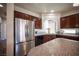 Kitchen featuring stainless steel refrigerator and appliances and dark wood cabinetry at 9450 Niagara Landing St, Las Vegas, NV 89139