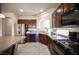 The kitchen features stainless steel appliances, and dark wood cabinets, including a gas range at 9450 Niagara Landing St, Las Vegas, NV 89139