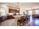 Bright kitchen featuring a spacious island with seating and dark wood cabinets at 9450 Niagara Landing St, Las Vegas, NV 89139