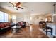 Open living area features hardwood floors, a cozy seating area, and seamless transition to kitchen and dining at 9450 Niagara Landing St, Las Vegas, NV 89139