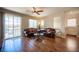 Bright living room with hardwood flooring, ceiling fan, sliding glass doors, and comfortable seating at 9450 Niagara Landing St, Las Vegas, NV 89139