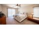 Carpeted main bedroom featuring blinds, a ceiling fan, and a sliding glass door leading to outside at 9450 Niagara Landing St, Las Vegas, NV 89139