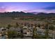 An aerial view of a desert community neighborhood with luxury homes and scenic mountain views at , Las Vegas, NV 89135