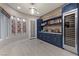 Stylish bar area with custom cabinets, wine fridge, marble countertops, and elegant lighting at , Las Vegas, NV 89135
