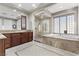 Bathroom features a glass shower, soaking tub, double sink vanity and travertine tile at , Las Vegas, NV 89135
