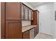 Butlers pantry featuring generous granite counter space, custom cabinetry, wine fridge, and under cabinet lighting at , Las Vegas, NV 89135
