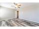 Spacious bedroom with gray wood-look floors and ceiling fan at 100 Samantha Rose St, Henderson, NV 89012